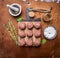 Raw meatballs on a cutting board with herbs and spices wooden rustic background top view close up