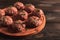 Raw meatballs, with micro greenery, on a cutting board, homemade, rustic, no people,