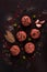 Raw meatballs, with micro greenery, with spices , on a black background , top view, homemade, no people,