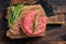 Raw minced homemade farmers grill beef burgers on chopping board with salt and rosemary. Wooden background. Top view