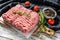 Raw minced pork on a chopping Board. Organic ground meat, forcemeat. White background. Top view