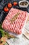 Raw minced pork on a chopping Board. Organic ground meat, forcemeat. White background. Top view