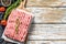 Raw minced pork on a chopping Board. Organic ground meat, forcemeat. White background. Top view. Copy space