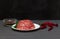 Raw minced on a white plate. Ingredients for cooking chili pepper. Black background