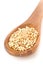 Raw, natural, uncooked buckwheat seed kernels in wooden spoon