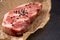 Raw New York Strip Steak on Brown Butcher Paper