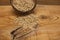 Raw oat grains in a coconut shell, ingredient for delicious healthy breakfast on a wooden background, copy space
