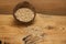 Raw oat grains in a coconut shell, ingredient for delicious healthy breakfast on a wooden background, copy space