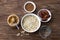 Raw oatmeal in a white bowl, peanut butter, dates fruits, cocoa and a glass of water, ingredients for delicious chocolate porridge