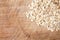 Raw oats wooden cutting board background.