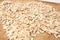 Raw oats wooden cutting board background.