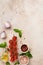 Raw orecchiette with parmesan cheese and tomatoes, basil, garlic and oil on light background with pepper on light brown