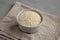 Raw Organic Carnaroli Rice in a Bowl on a gray background, side view