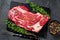 Raw Organic chuck eye roll meat steak cuts. Black background. Top view