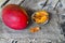 Raw organic dried mango in a glass bowl and fresh ripe mango fruit on wooden rustic table.