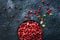 Raw organic fresh cowberry or lingonberry in a bowl on dark stone table