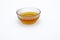 Raw organic honey or nectar in a transparent glass bowl isolated on white.