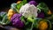 Raw Organic Multi Colored Cauliflower Ready to Cook. Cauliflower assortment with leaves, close up. Purple, yellow and white whole