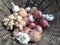 Raw organic root vegetables kept in a cane basket. potatoes, onions, garlic, ginger