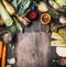 Raw organic vegetables ingredients for healthy cooking on rustic wooden background, top view, country food