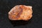 raw orthoclase stone on dark background