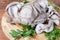 Raw oyster mushrooms with fresh parsley twigs on cutting board