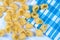 Raw pasta background, italian traditional macaroni on blue plaid cloth,