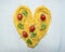 Raw pasta with cherry tomatoes and basil leaves lined heart, valentines day on wooden rustic background top view close up