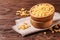 Raw pasta ditalini in a wooden bowl