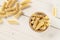 Raw pasta fusilli bucati on grey wood