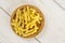 Raw pasta gemelli on grey wood