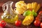 Raw pasta olive oil tomatoes. italian cuisine in rustic kitchen