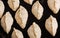 Raw pasty pies lying on a baking sheet. Close-up view