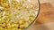 Raw Peruvian Canary beans soaked in water in glass bowl on wooden table