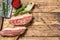 Raw picanha or Top Sirloin Cap steak on a chopping Board. wooden background. Top view. Copy space