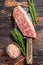 Raw picanha or Top Sirloin Cap steak on a meat cleaver. Dark wooden background. Top view