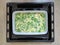 Raw pie with green onion cut shoots in baken roaster before baking. light beige wooden background. Modern baking cooking style