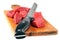 Raw pieces of beef meat on a cutting board with a knife close-up on white background