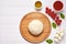 Raw pizza dough with baking ingredients on cutting board: dough, mozzarella, tomatoes sauce, basil, olive oil, cheese