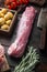 Raw pork fillet tenderloin. Fresh meat with ingredients and herbs for grill or baking, sage, potatoe with old butcher cleaver