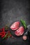 Raw pork meat. Fresh steaks on slate board on black background