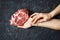 Raw pork meat. Woman hands holding one slice of steak