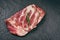 Raw pork ribs meat on black plate background - Fresh pork spare ribs for cooking roasted or grilled , Pork bone with rosemary