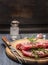 Raw pork with rosemary on a wooden board with a fork, close up