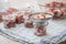 Raw pork shoulder in preserving screw-cap glass jars and metal funnel on towel for home-made pressure canning meat as Russian