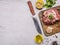 Raw pork steak with spices, garlic and herbs, lemon and butter knife for meat, border, place for text on wooden rustic background