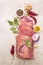 Raw pork tenderloin with vegetables and spices. Cooking meat background, fresh brisket boneless steak on stone background, top