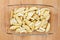 Raw potatoes in a glass tray, ready to be roasted