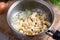 Raw potatoes sliced in a saucepan on a wooden background