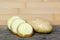 Raw potatoes sliced on wooden table